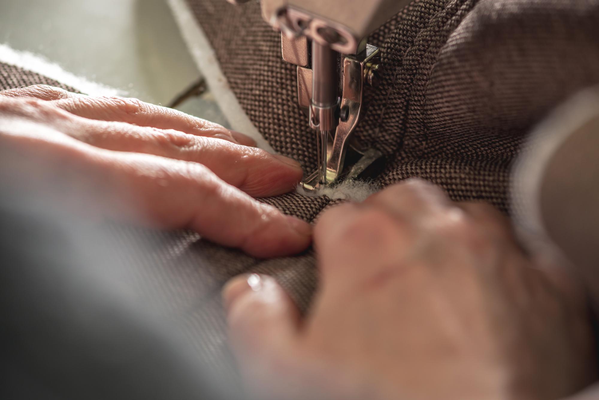founder stitching a pattern by hand